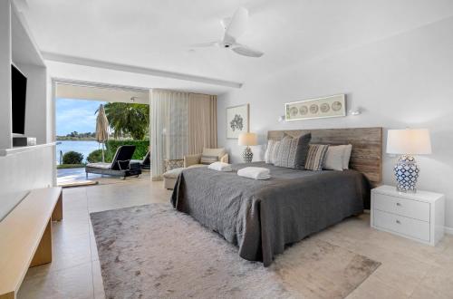 a bedroom with a large bed and a living room at Noosa Quays Waterfront Accomodation in Noosa Heads