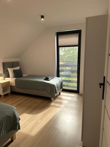 Katil atau katil-katil dalam bilik di Apartamenty Literówka