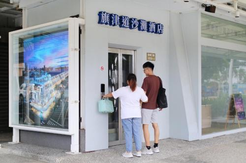 a man and a woman standing outside of a building at In Young Hotel in Kaohsiung