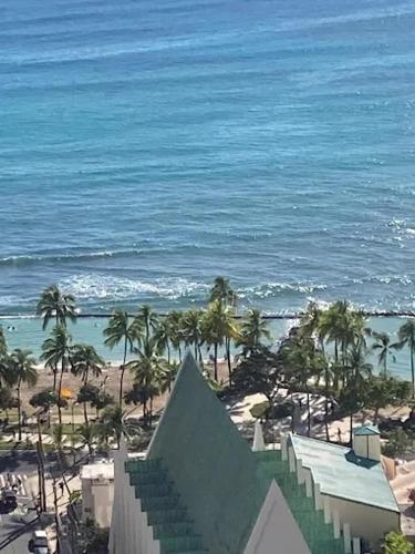 a view of a beach with palm trees and the ocean at Lovely APT AC, Free Parking, Ocean View in Honolulu