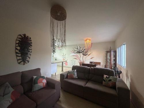 a living room with a couch and a table at Recanto do sossego!! in Morretes