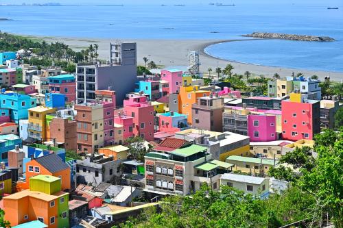 a city with colorful buildings and the beach at In Young Hotel in Kaohsiung