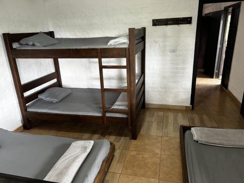 a room with three bunk beds in a room at La Gloria Ranch 