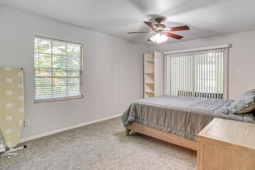 a bedroom with a bed and a ceiling fan at Group Getaway with Deck and Yard in Lakeland! in Lakeland