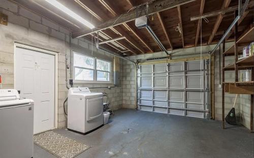 a garage with a washer and dryer in it at Retreat on the Bayou in Port Richey