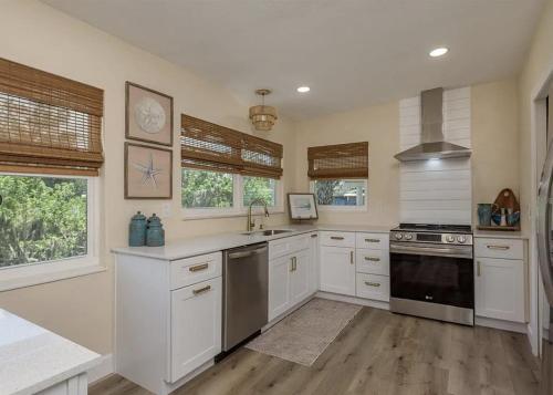 a kitchen with white cabinets and a stove top oven at Retreat on the Bayou in Port Richey