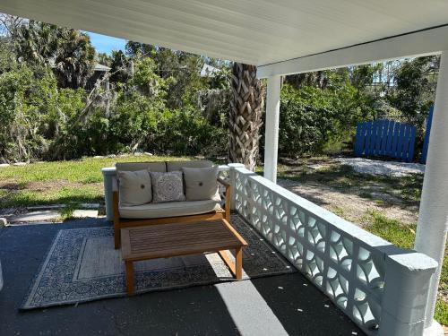 a couch sitting on a porch with a table at Retreat on the Bayou in Port Richey