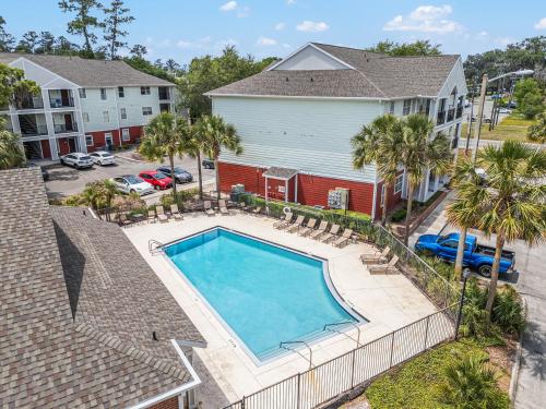 an overhead view of a swimming pool in front of a house at Gator Suites - Near UF, Shands & VA! in Gainesville