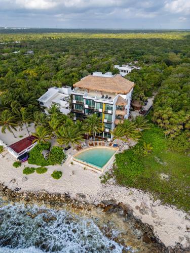 an aerial view of a resort with a swimming pool at Angelina 28 Beachfront and Family Apartments - Modern and Relaxing Long Stays - 20 min from Cancun Airport in Puerto Morelos