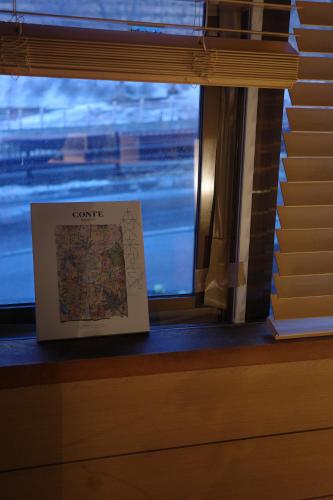 a book sitting on a window sill next to a map at 層雲峡温泉 ホテル雲井 in Kamikawa