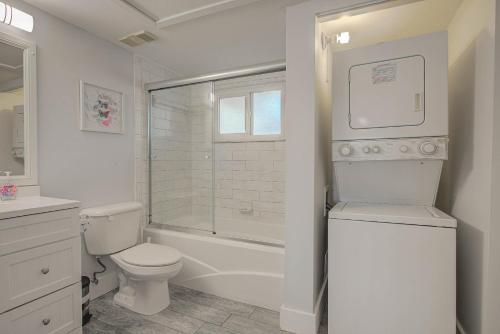 a white bathroom with a toilet and a shower at Ocean Side Complex with Heated Pool B-15 in Saint Augustine
