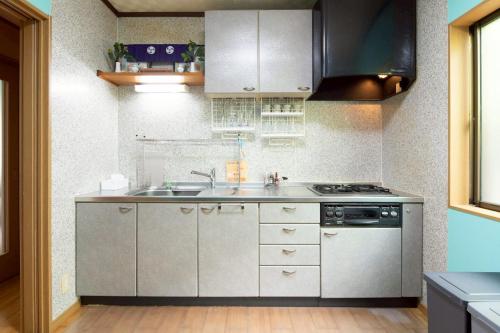 a kitchen with a sink and a stove at Nagata House in Ise