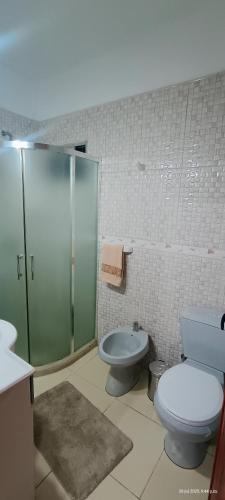 a bathroom with a shower and a toilet and a sink at A pasitos del mar in La Coronilla