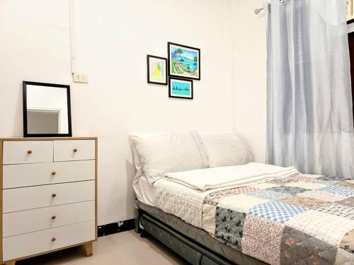 a bedroom with a bed and a dresser at 3Bed&Bath family friendly house in Davao City