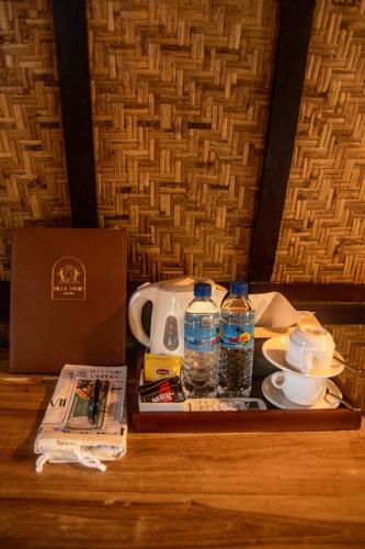 a table with a tea kettle and bottles of water at Villa Tahid in Gili Air