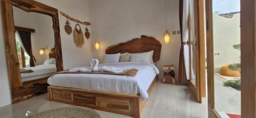 a bedroom with a large bed with a large mirror at 1 Bedroom Private Villa with Kitchen in Mendaya