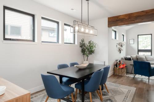 una sala da pranzo con tavolo nero e sedie blu di Silly Goose Lodge a Granby