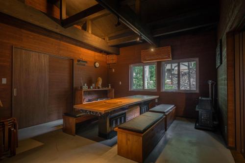 a large room with a table and bench in it at Kussharoko Sauna Club in Teshikaga