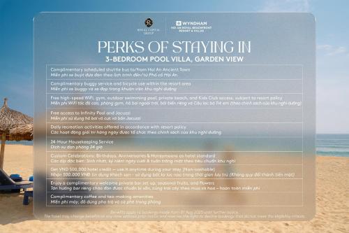 a sign on the beach with a beach chair at Wyndham Hoi An Royal Beachfront Resort & Villas in Hoi An