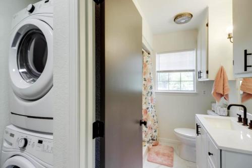 a bathroom with a washer and dryer next to a sink at Oak St in Mountain View