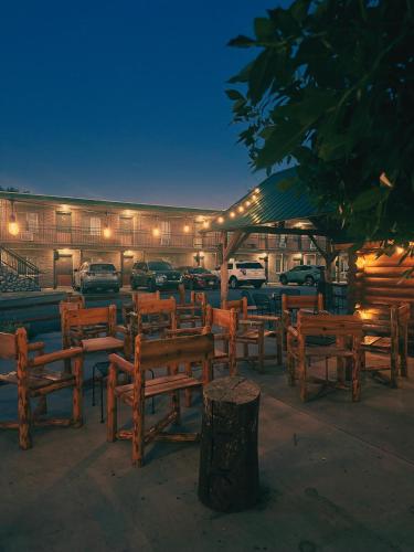 a group of wooden benches in front of a building at Elk Antler Inn in Thermopolis