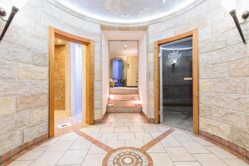 a hallway with a stone wall and a door at Apparthotel AlpenChalet in Neukirchen am Großvenediger