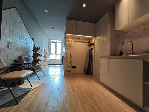 a kitchen with a table and chairs in a room at Atour Hotel Qingdao North Station Middle Chongqing Road in Qingdao