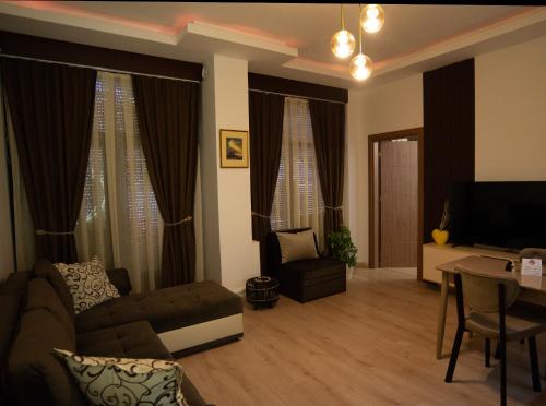 a living room with a couch and a table at Gratia Apartments in Kumanovo