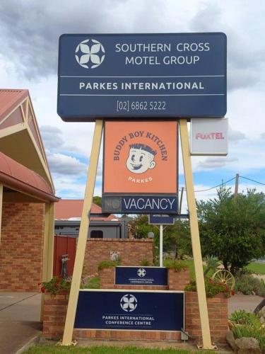 a sign for the southern cross model group in front of a building at Parkes International in Parkes