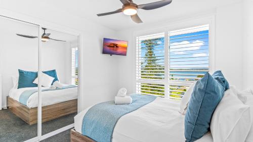 a bedroom with two beds and a window at Mirage 801 in Tuncurry