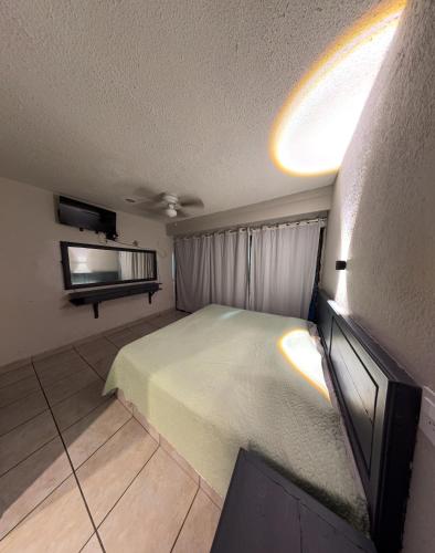 a bedroom with a bed and a flat screen tv at Hotel Nuevo Vallarta in Guadalajara
