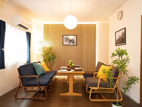 a living room with two chairs and a table at Setouchi Inn Minamoみなも in Takamatsu