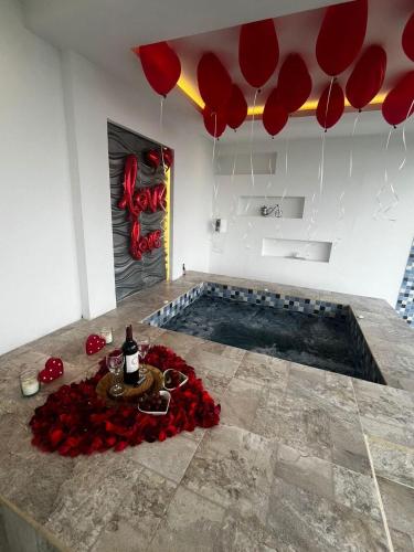 a room with a pool with red flowers and balloons at BALCÓN DE SANTA MARÍA 2 in Dosquebradas