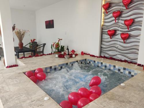 a pool with red balloons in the middle of a room at BALCÓN DE SANTA MARÍA 2 in Dosquebradas