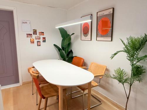 a white dining room with a white table and chairs at KojjeeBnB Bed Room2, Qeen size bed2, TV 2, #KSPO#JYP#Hanriver in Seoul