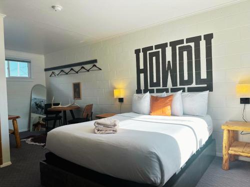 a bedroom with a large bed with a large headboard at Elk Antler Inn in Thermopolis