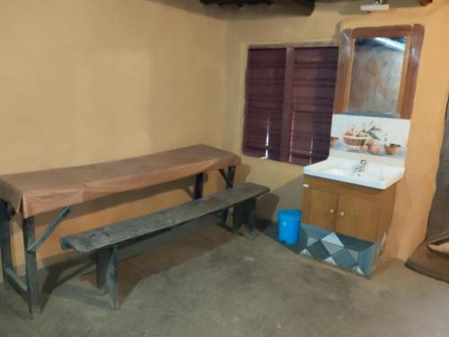 a bathroom with a wooden table and a sink at Natural mudhouse in Kanthalloor