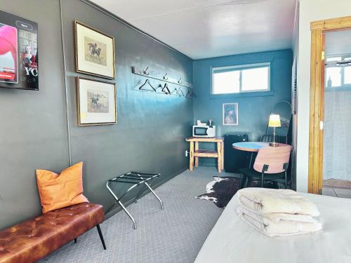 a room with a bed and a couch and a table at Elk Antler Inn in Thermopolis