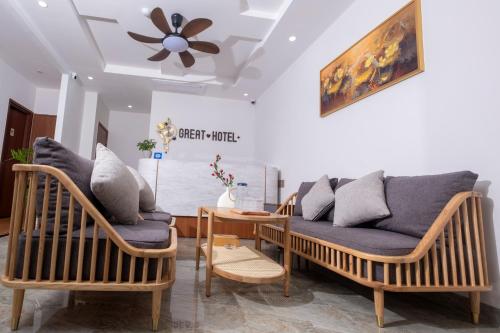 a living room with two chairs and a couch at Great Hotel Phú Quốc in Phu Quoc