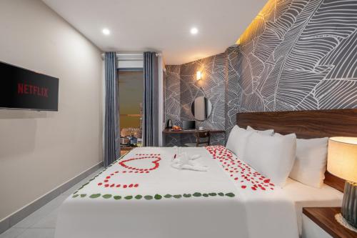 a hotel room with a bed with a red heart on it at KLY Hotel Vung Tau in Vung Tau