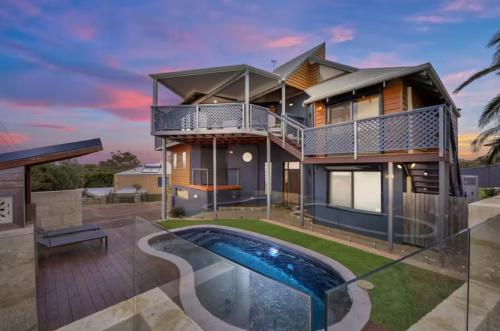 a house with a swimming pool in front of it at Endless Summer Beach House in Falcon