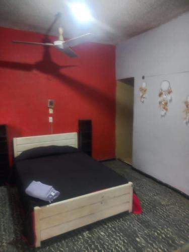 a bedroom with a bed and a ceiling fan at Casa Rokah in Lázaro Cárdenas