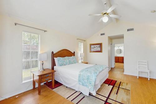 a bedroom with a bed and a ceiling fan at Pelican Pete in Corpus Christi