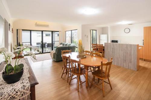 a living room with a table and a dining room at Thomas Place- WIFI, Kayaks, Bikes, Secure Yard in Busselton