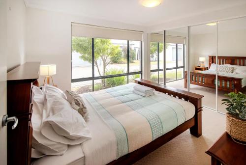 a bedroom with a bed and a large window at Thomas Place- WIFI, Kayaks, Bikes, Secure Yard in Busselton