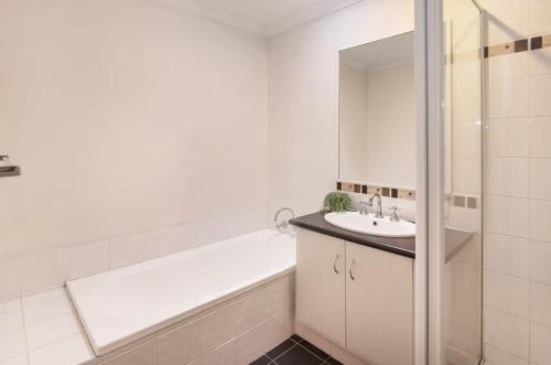 a bathroom with a bath tub and a sink at Thomas Place- WIFI, Kayaks, Bikes, Secure Yard in Busselton