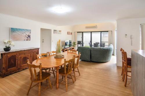 a dining room and living room with a table and chairs at Thomas Place- WIFI, Kayaks, Bikes, Secure Yard in Busselton