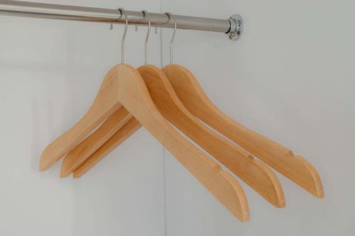 a group of wooden utensils hanging from a rack at Marina Villa 1 in Yogyakarta