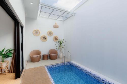 a house with a swimming pool in a room at Marina Villa 1 in Yogyakarta