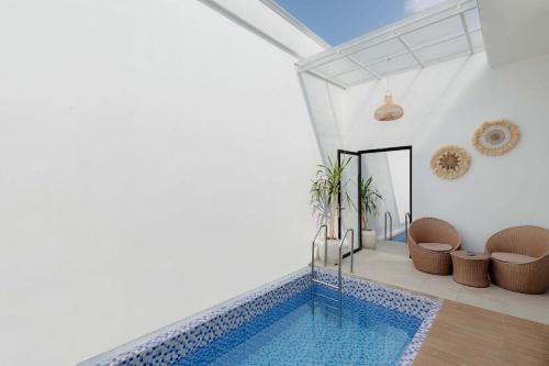 a house with a swimming pool in a room at Marina Villa 1 in Yogyakarta